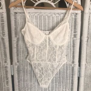 Never worn. White lace bodysuit
